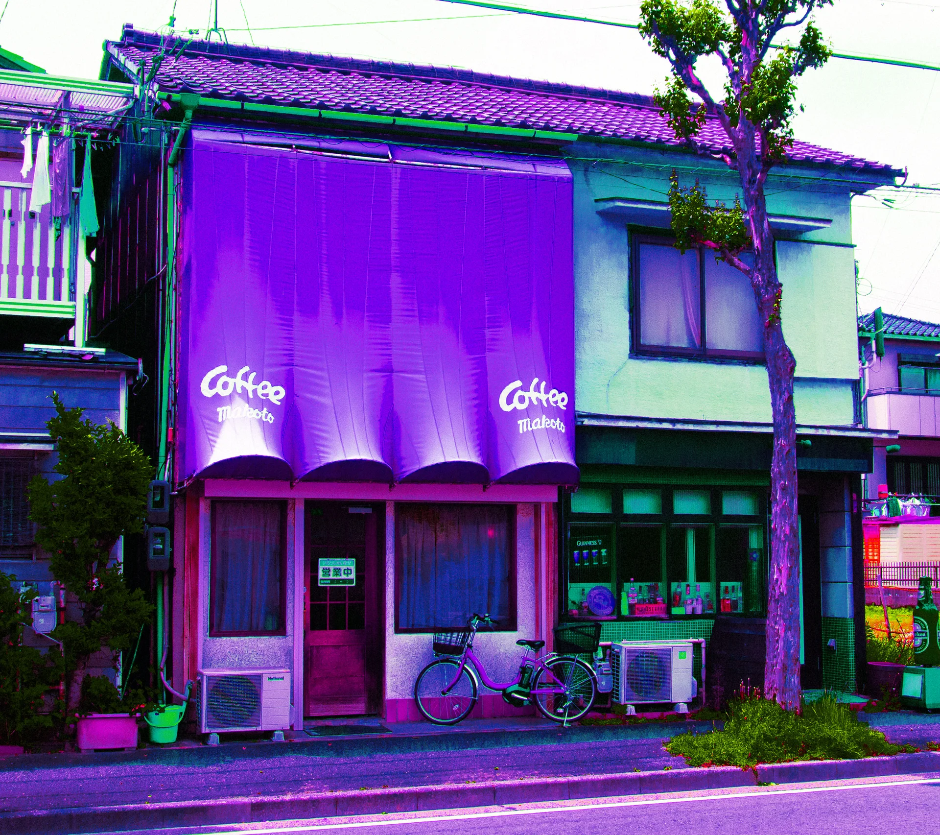 A broad purple coffee awning covers a small storefront beside a green facade, bicycle, and pruned tree.