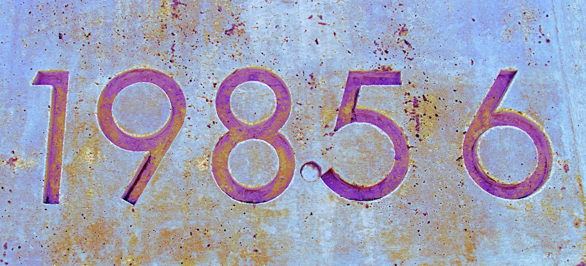 Purple numerals 19856 span a pale blue surface mottled with small rust-colored stains.