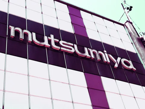 Raised silver lettering spans a facade patterned with large white and dark burgundy squares.
