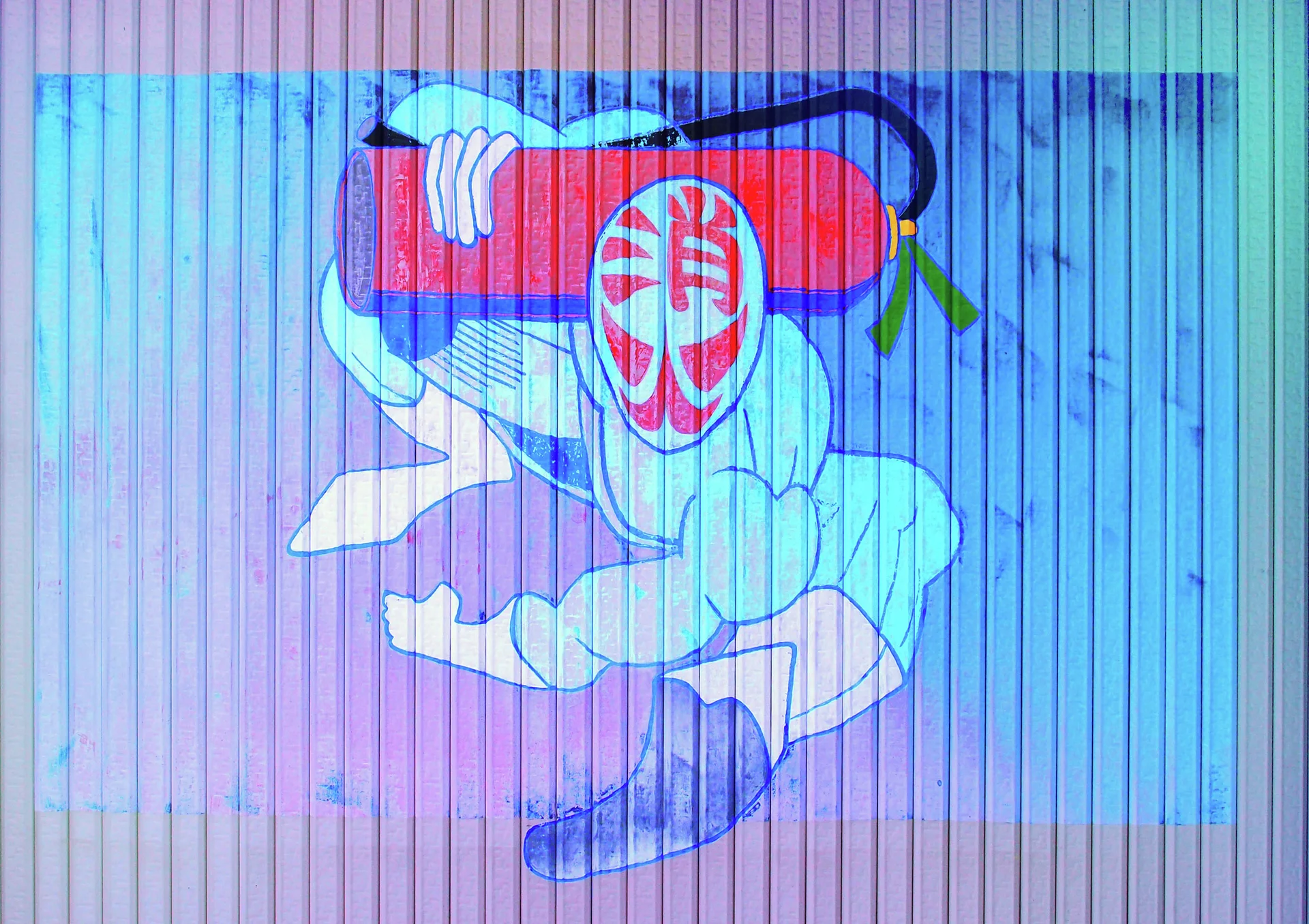 A painted masked figure carries a large red cylindrical object across a blue corrugated shutter.