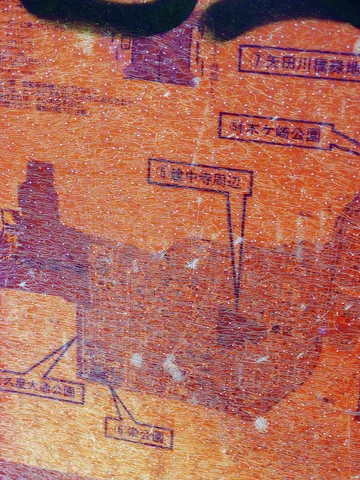 Faint purple labels and stepped lines cover a grainy orange surface with darker irregular patches.